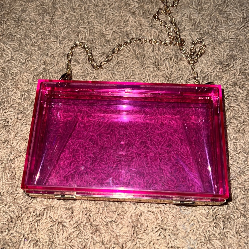 It’s a pink clear purse with chain for shoulder.